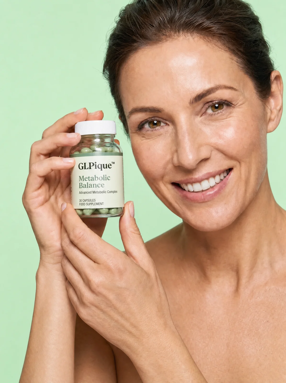Woman in her forties smiling and holding a bottle of GLPique Metabolic Balance